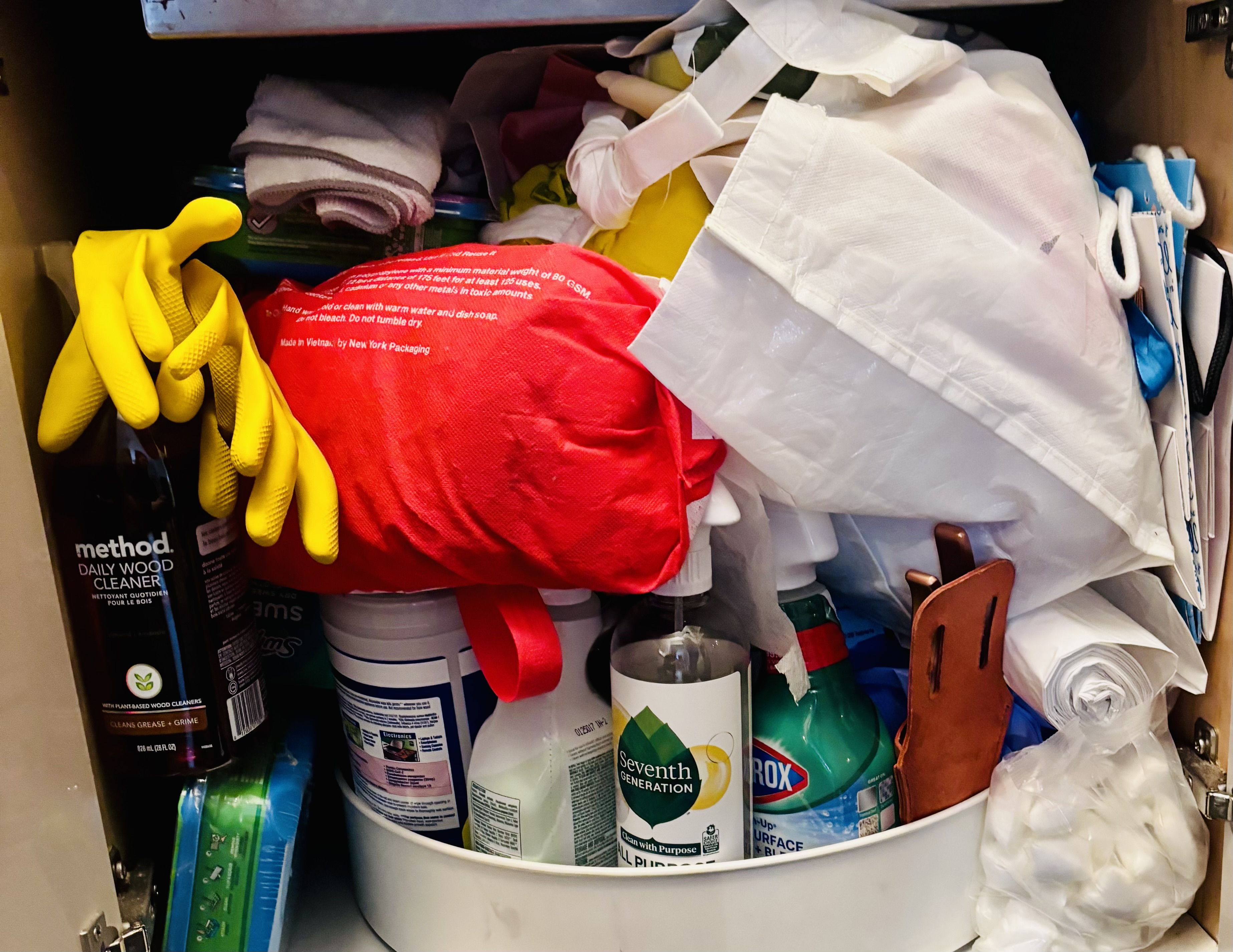 Before: chaotic under-sink cabinet