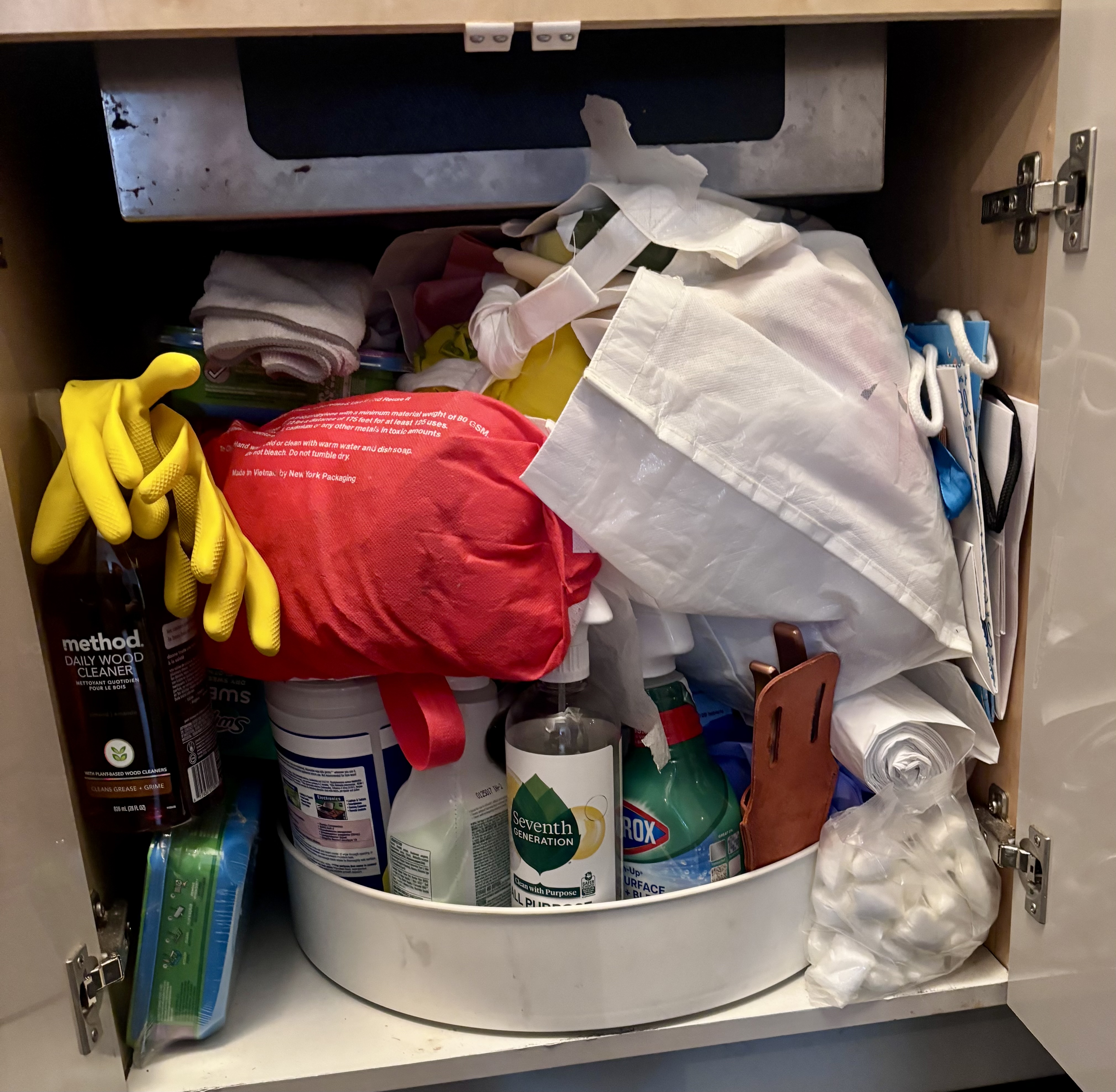 Before: chaotic under-sink cabinet