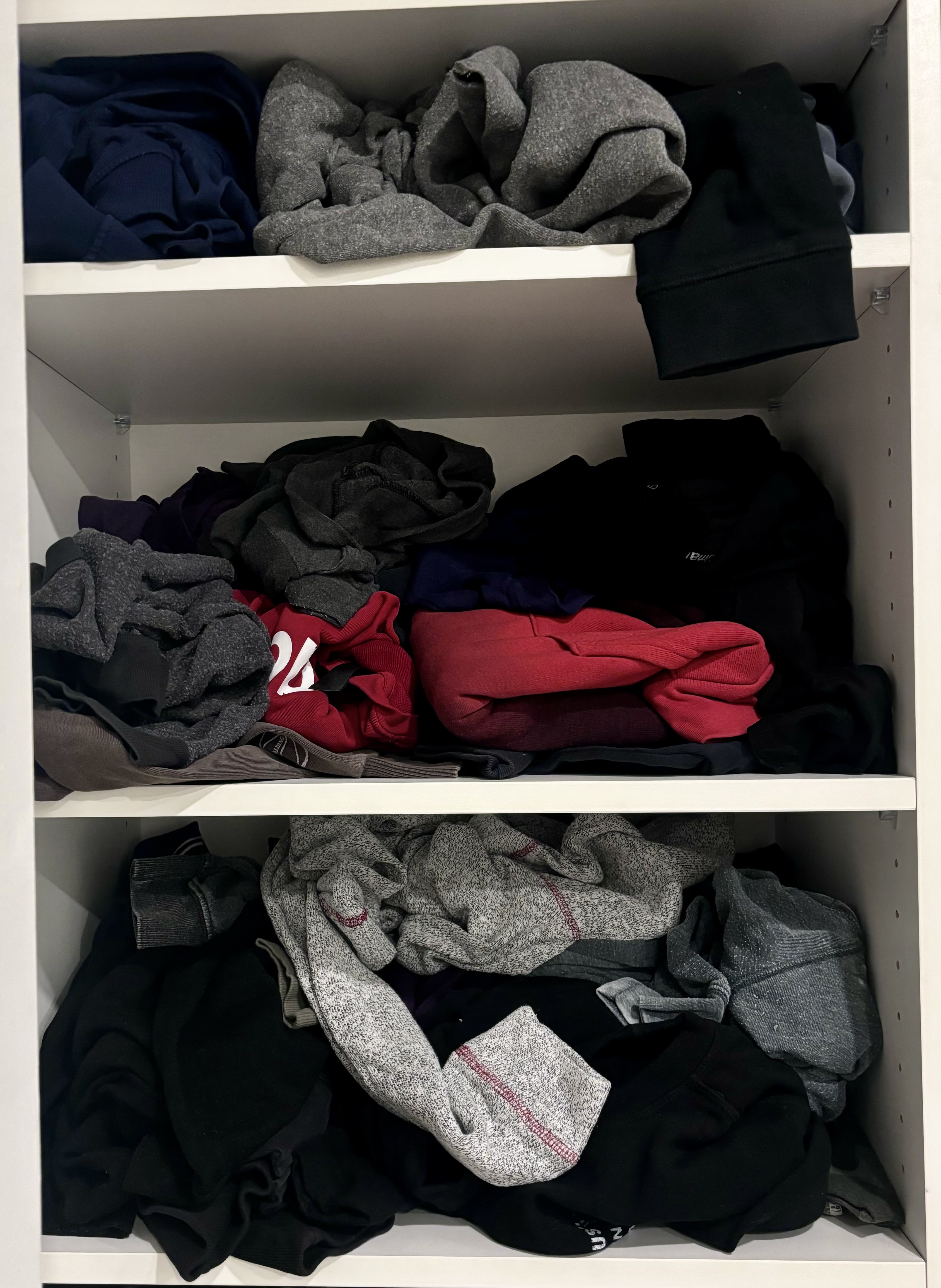 Before: messy clothing shelves